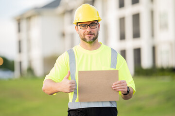 Civil Worker engineer african american man wearing hard hat and smiling. happy positive manager or contractor, heavy machinery. Construction worker on top of a building. builder in working uniform