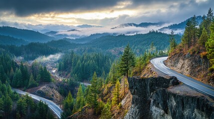 A mountain range with a winding road that leads to a cliff