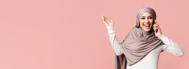 Unexpected Call. Surprised Muslim Woman In Hijab Talking On Cellphone And Emotionally Gesturing...