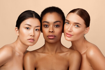 Natural Beauty Concept. Three Pretty Girls Posing Shirtless On Gray Studio Background, Looking At Camera