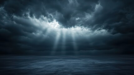Obraz premium Dramatic Stormy Sky with Sun Rays Breaking Through Dark Clouds Over a Calm Ocean Horizon