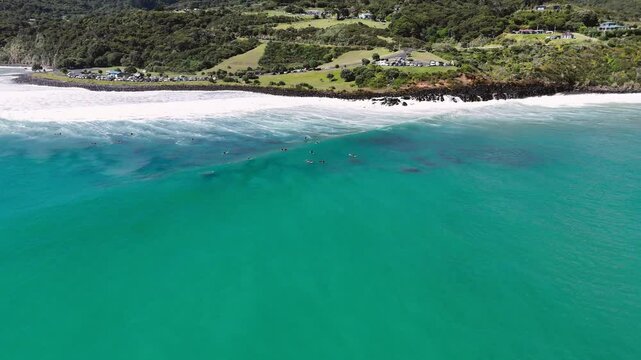 high view of surfers on a beach in New Zealand