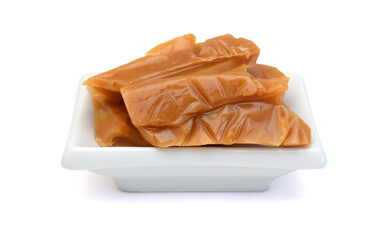 Caramel candies isolated on white background