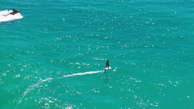Man using a Flying surfboard in Raglan, New Zealand