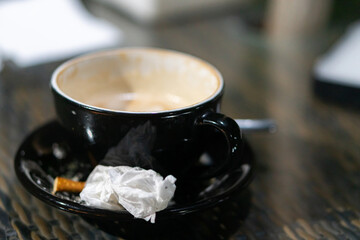 Empty Coffee Cup with Cigarette and Tissue