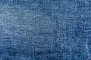 close-up blue denim jeans fabric showing detailed texture with a dark blue color and a stylish...