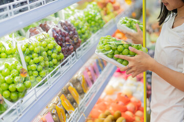 Shopping for Fresh Green Grapes in Supermarket