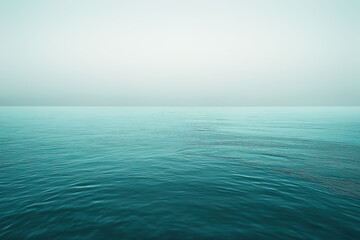 Turquoise ocean water merging with the foggy horizon