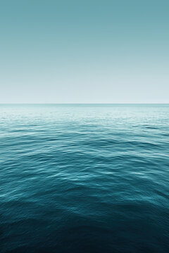 Ocean horizon stretching into distance under blue sky