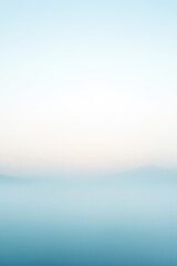 Obraz premium Minimalist landscape of blue mountains fading into foggy sky