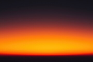 Fototapeta premium Bright orange and yellow sunset fading to black