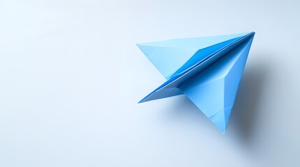 A Blue Paper Airplane in Flight on a White Background
