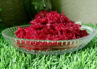 Grated beetroot in bowl.