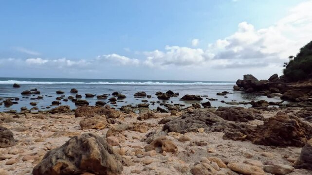Rocky beach in Wonogiri, south of Java Island, Indonesia with cloudy sky in summer. Beach video loop