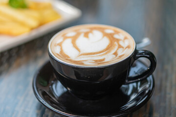 Artistic Latte in Black Cup