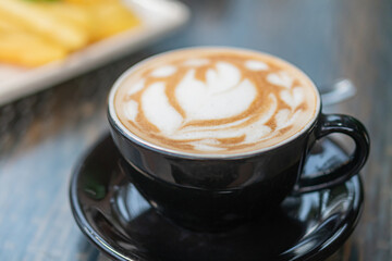 Artistic Latte in Black Cup