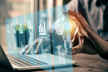 Close up hand choose light bulb or lamp with bright and business growth icons for human resources or leadership and creativity thinking idea motivation or vision and knowledge learning. © Jintana