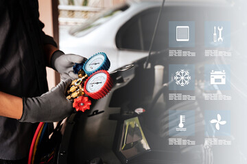 Car mechanic uses air refrigerant meter manifold gauge to check car air conditioner system heat...
