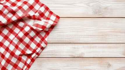 Checkered red and white tablecloth spread on a rustic wooden table. Ideal for country kitchen or picnic concepts.