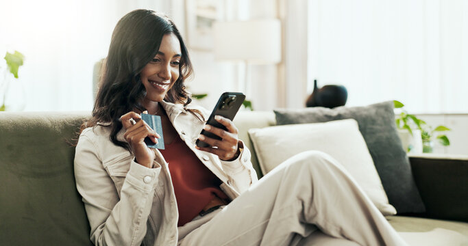 Cellphone, card and woman in house, online shopping and smile for purchase, relax and happy customer. Home, girl and payment for membership in social media, digital and person with credit in lounge