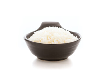 Cooked Thai jasmine rice served in a black bowl against a white background. The contrast between the aromatic, fluffy rice and the sleek black bowl emphasizes the simplicity