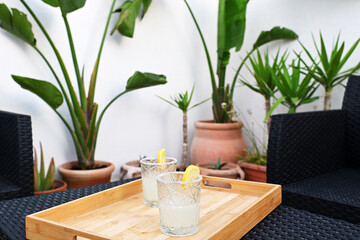Two glasses with fresh margarita cocktail on a table on the terrace