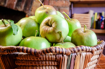 Close-up of green apples in a woven wicker basket