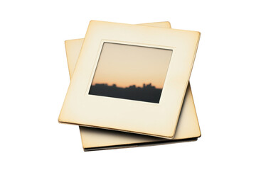 Vintage photo slides with a blurred image of a sunset in the background. Ideal for nostalgia and retro-themed projects.