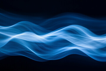 Obraz premium Smooth, flowing blue light waves on a dark background, creating an abstract and futuristic visual effect with soft gradients and a sense of motion