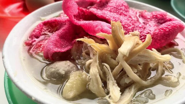 Close-up footage of a delicious Indonesian chicken noodle soup, mie ayam. Perfect for food blogs, travel documentaries, or culinary content.
