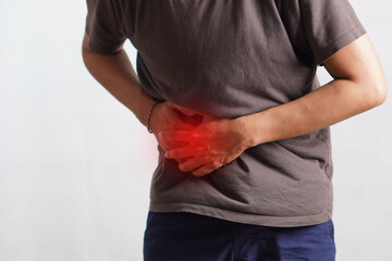 Fitness, stomach ache and man outdoor after running, workout or exercise. Sports, abdominal pain...