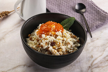 Curd with granola and orange jam