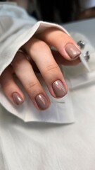 Fototapeta premium The beauty of the natural nails. Perfect clean manicure. New trendy nail arts on young women hand