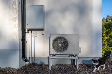 Electrical cabinet and air source heat pump outside house