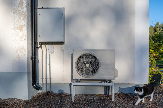 Electrical cabinet and air source heat pump outside house
