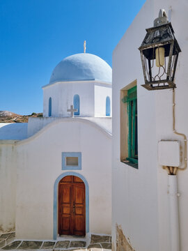 White church with blue dome  in Lefkes village, Paros island, Cyclades, Greece