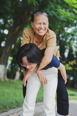 Obraz premium Young Asian woman with her mother in the park