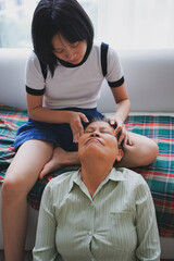 Asian woman massaging her mother
