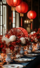 Elegant table setting featuring red lanterns and floral arrangements for a festive gathering in an ornate venue