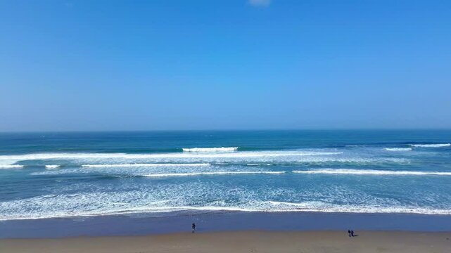 Drone footage of waves and blue sky at Parangtritis Beach, Yogyakarta, Indonesia