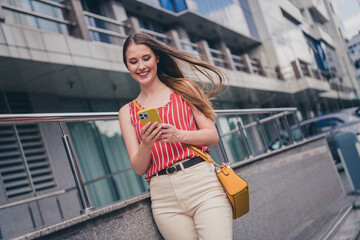 Photo of lovely adorable girl wear trendy outfit hold modern device summer time weather outdoors