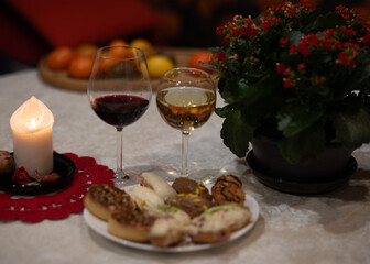 white burning candle and glass of wine, holiday celebration, table decoration