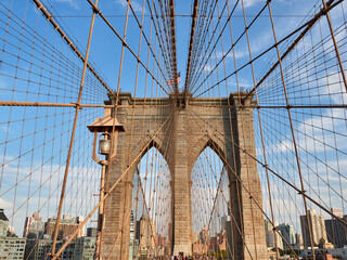 Fototapeta premium Brooklyn Bridge, connects the boroughs of Manhattan and Brooklyn in New York City. It is a historic symbol of New York and a fundamental part of the city, as it crosses the East River connecting Manha