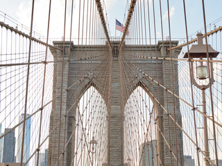 Fototapeta premium Brooklyn Bridge, connects the boroughs of Manhattan and Brooklyn in New York City. It is a historic symbol of New York and a fundamental part of the city, as it crosses the East River connecting Manha