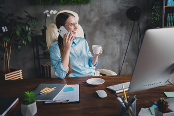 Photo of cheerful positive lady recruiter dressed shirt eyewear drinking coffee talking modern...