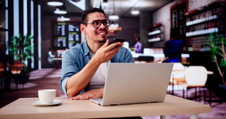 Man Drinking Coffee And Working On Laptop. Sending Voice Message