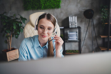 Photo of cheerful positive lady recruiter dressed shirt earphones communicating device indoors...