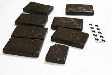 Briquettes of the narcotic drug hashish under analysis in a police crime lab, crime investigation