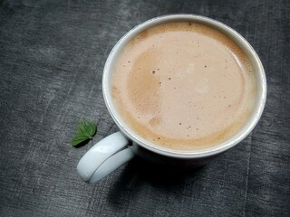 A cup of warm capuccino coffee. very delicious, flat lay.