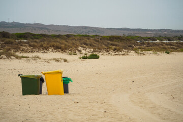 Recycling bins in a tourist beach in Andalucia, Spain.